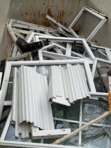 Alte Fenster und Fensterrahmen im Container nach einer Räumung in Frankfurt